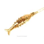 A vintage 9ct gold articulated fish pendant on 9ct chain