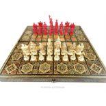 A late 19th / early 20th century Chinese carved ivory chess set on a north African board