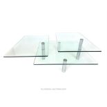 A contemporary designer square three tier glass table, raised on four cylindrical chrome legs,