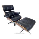 A 20th century simulated rosewood and black leather designer reclining chair and matching footstool,