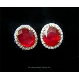 A pair of ruby and diamond cluster earrings