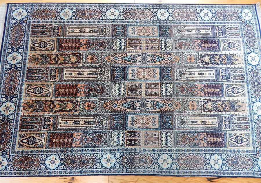 A pure silk Kashmir rug, the field filled with tiles, surrounded by one frieze and two running borde - Image 2 of 3