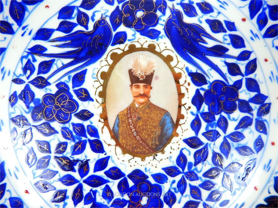 An early 20th century Persian blue and white plate, featuring Nazerldin Shah, with gold - Image 2 of 3