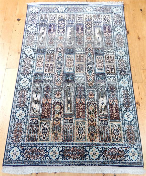 A pure silk Kashmir rug, the field filled with tiles, surrounded by one frieze and two running borde