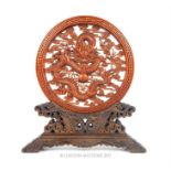 A carved wooden Chinese table screen featuring a dragon to its centre; 21.5cm high.