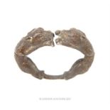 An eastern white metal bracelet decorated with panthers; 9 cm diameter.