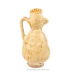 A Kashan cream glazed jug, shaped in bird form; 14cm high; small chip to top; 14cm high.