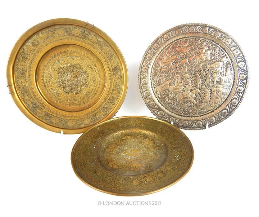 A 19th century Persian bronze dish, engraved with seven figures to the centre, and two others