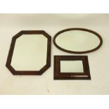A collection of three mirrors including a rectangular rosewood wall mirror