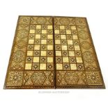 A North African inlaid folding chess board, complete with draughts pieces