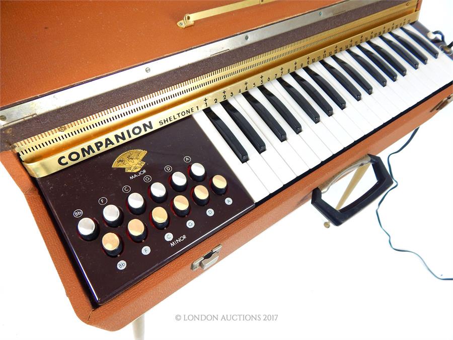 A vintage 1960's Companion Sheltone travel organ / piano, the case covered in brown rexine - Image 2 of 3