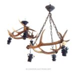 Two vintage antler mounted ceiling lights; with each light featuring three interlocked antler stag