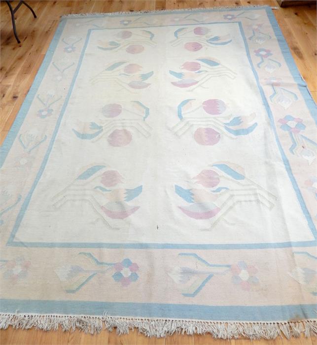 A large Indian kelim carpet, decorated with flowers on an ivory field