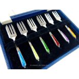 A cased set of six silver enamelled pastry forks.