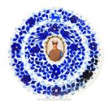 An early 20th century Persian blue and white plate, featuring Nazerldin Shah, with gold