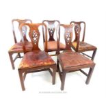 A set of five George III walnut Chippendale design dining chairs