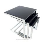 A nest of three chromed aluminium cantilever occasional tables, with black glass tops