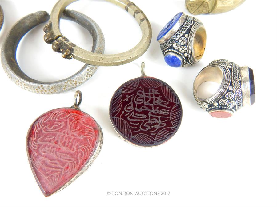 A selection of Bedouin white metal jewellery, comprising; two large rings mounted with intaglio - Image 5 of 5