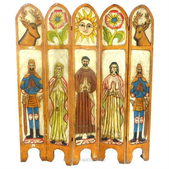 A brightly painted carved Mexican teak four fold screen, with arched top, carved with animals and