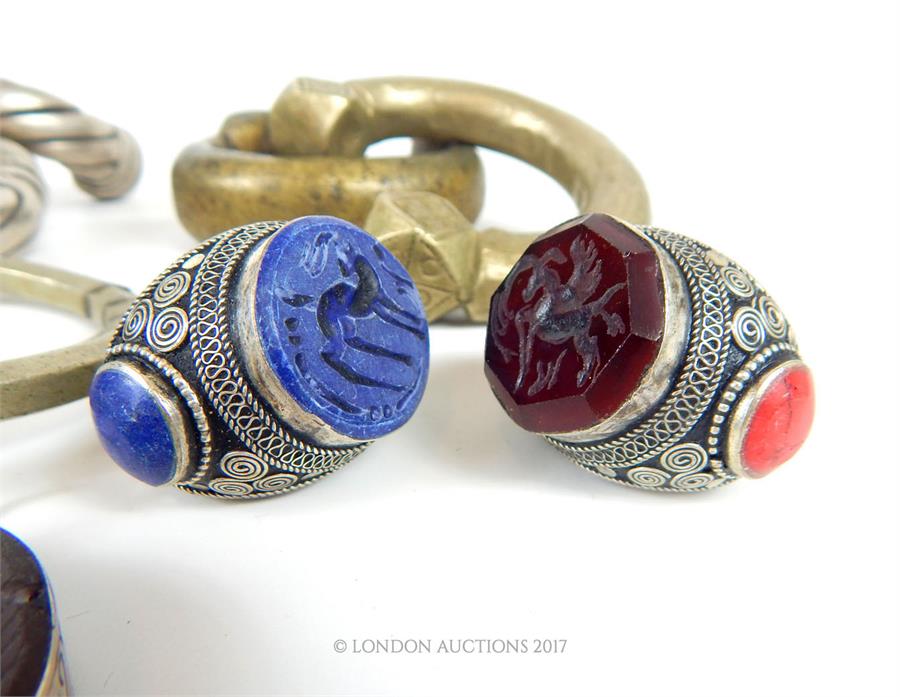 A selection of Bedouin white metal jewellery, comprising; two large rings mounted with intaglio - Image 4 of 5