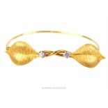 A high ct yellow gold diamond set leaf form bracelet