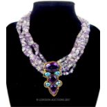 A six strand amethyst and quartz necklace with amethyst and blue topaz set pendent set in silver,