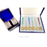 A set of six Danish silver gIlt and enamel coffee spoons and a cased pair of napkin rings