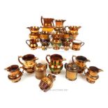 A collection of 19th century copper lustre pottery jugs, of varying sizes, most decorated with an
