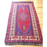 A Caucasian flatweave rug, the medallion on a red field with blue spandrels