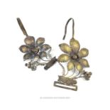 A pair of unusual white metal, Chinese wedding mosquito net hooks in the form of large flower