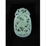 A Chinese white jade carving, decorated with an exotic bird amongst scrolling foliage