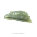 A Chinese carved jade bird figure resting upon a carved leaf