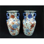 A pair of large Chinese porcelain vases decorated in the Imari palette