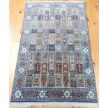 A pure silk Kashmir rug, the field filled with tiles, surrounded by one frieze and two running borde