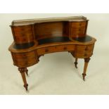 A mid Victorian mahogany inverted serpentine fronted bonheur du jour