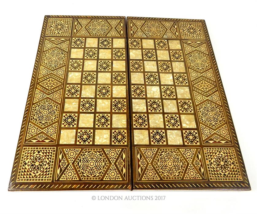 A North African inlaid folding chess board, complete with draughts pieces