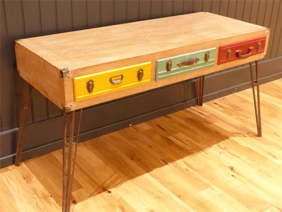 A contemporary desk with briefcase style drawers; raised upon metal legs. 163w x 60d x 80h cm.