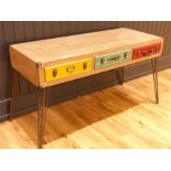 A contemporary desk with briefcase style drawers; raised upon metal legs. 163w x 60d x 80h cm.