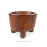 A small carved Samoan (Oceanic) kava bowl, raised on four cylindrical legs, 7cm high, 8cm wide
