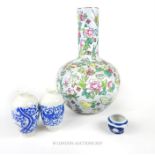 A Chinese porcelain vase, hand painted with flowers and butterflies in the famille rose palette