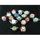 A collection of sixteen mostly Chinese and Japanese teapots, to include one decorated in colour
