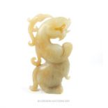 A Chinese jade carving in the form of a mythical serpent standing on it's hind feet