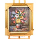 An oil on canvas still life depicting a vase of flowers, signed W Adam, in a gilt frame