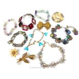 A collection of vintage, costume bracelets and brooches