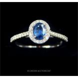 An 18t white gold sapphire and diamond cluster ring of approximately 1.1ct