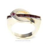 A handmade sterling silver ring featuring a stylised buckle design