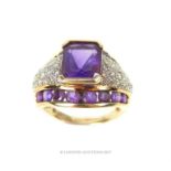 A 9 ct yellow gold amethyst and diamond bombe dress ring