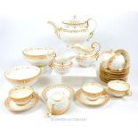 A 19th century porcelain tea set featuring a delicate, gilded and red floral pattern