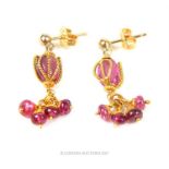 A pair of yellow gold pink sapphire drop earrings; both stamped "750"