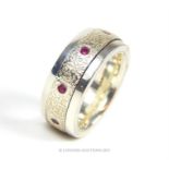 A handmade sterling silver chunky ring inset with eight round brilliant cut rubies.